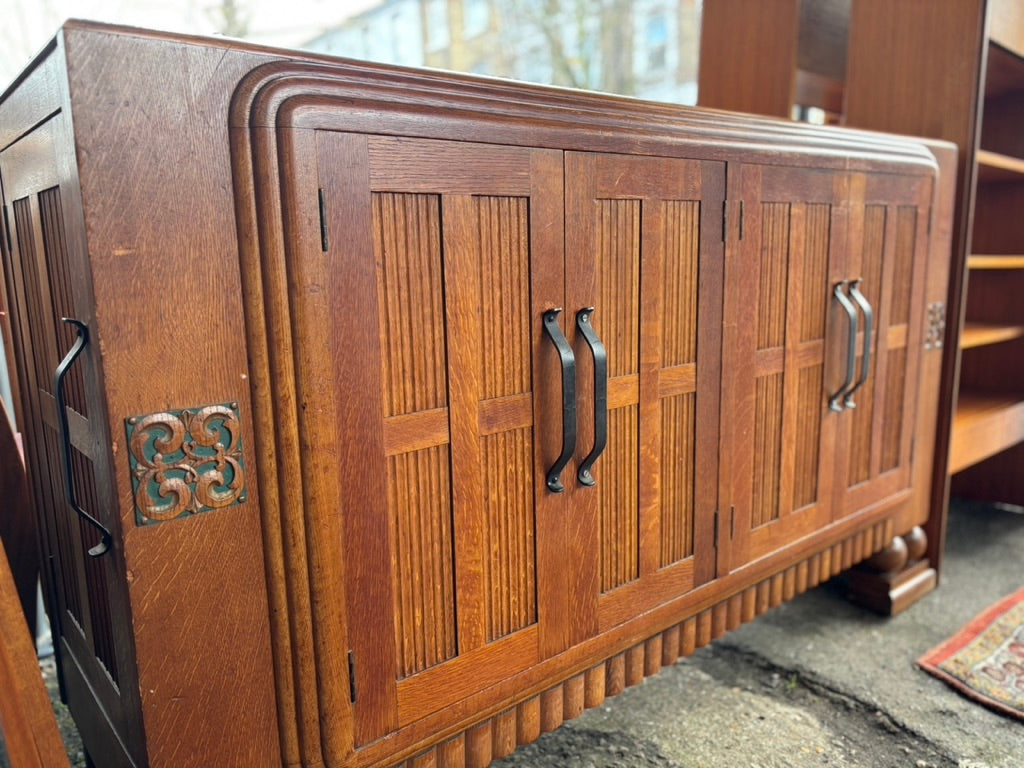 Wooden sideboard with decorative elements on a concrete floor