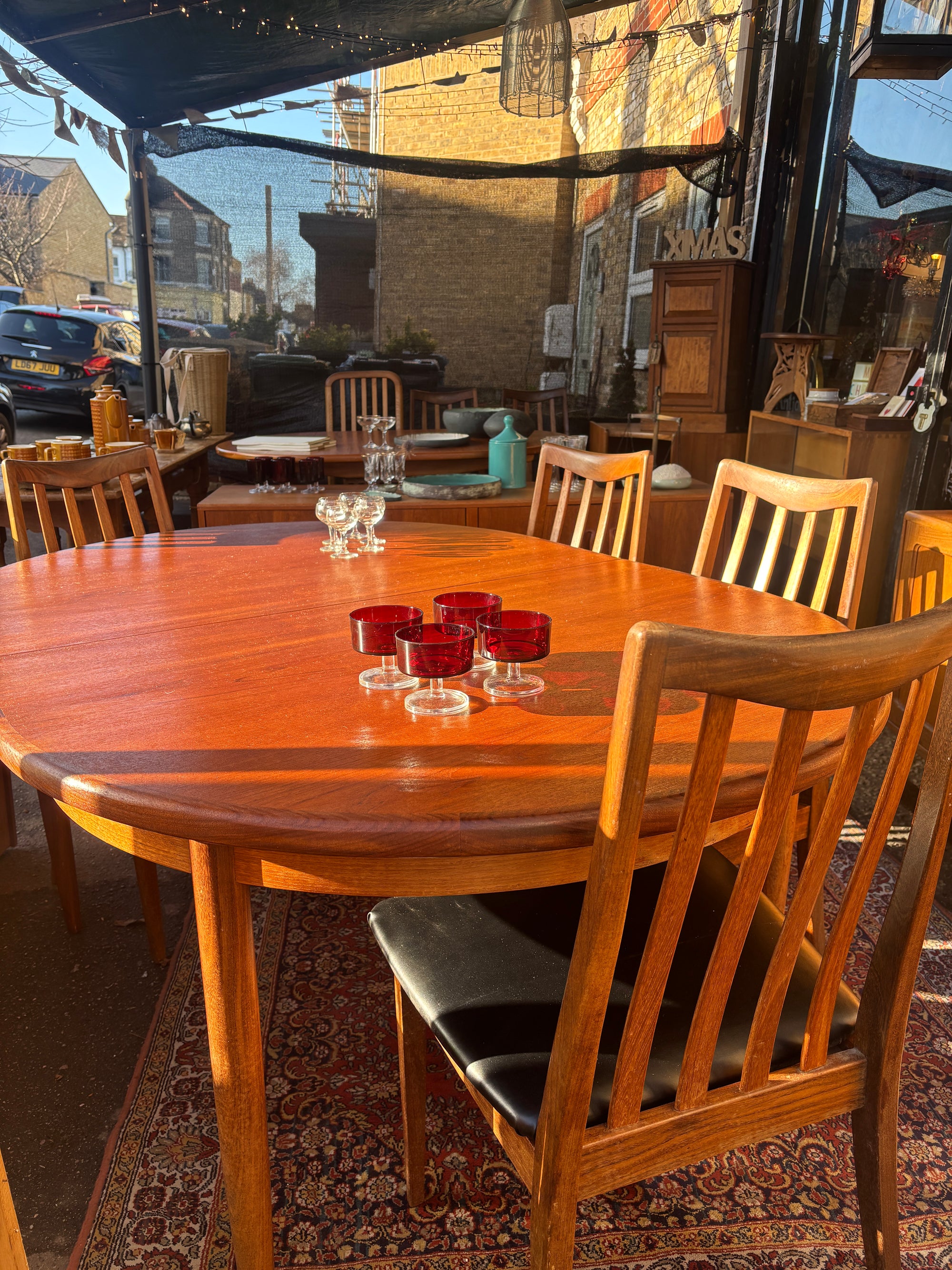 Mid Century early G-Plan teak extendable table and chairs with black vinyl